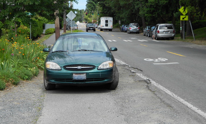 Photo of car illegally parked on sidewalk