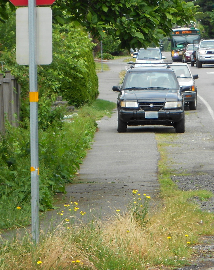 Photo of cars illegally parked on sidewalk